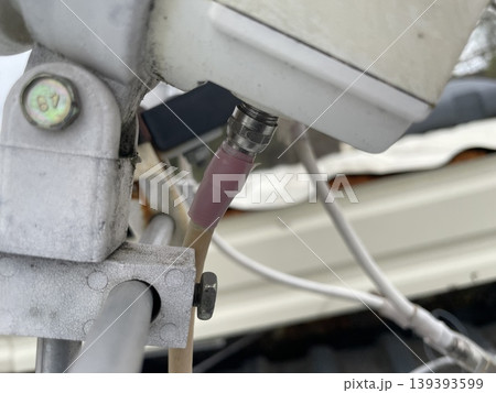 Adjusting satellite dish signal on rooftop Adjusting satellite dish signal on rooftop 139393599