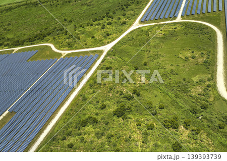 Aerial view of big sustainable electric power plant with many rows of solar photovoltaic panels for producing clean electrical energy. Renewable electricity with zero emission concept Aerial view of big sustainable electric power plant with many rows of solar photovoltaic panels for producing clean electrical energy. Renewable electricity with zero emission concept 139393739