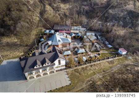 Aerial view of big house mansion complex on fenced property in ecological area on bright sunny day. Modern architecture, riches and luxury concept. Aerial view of big house mansion complex on fenced property in ecological area on bright sunny day. Modern architecture, riches and luxury concept. 139393745