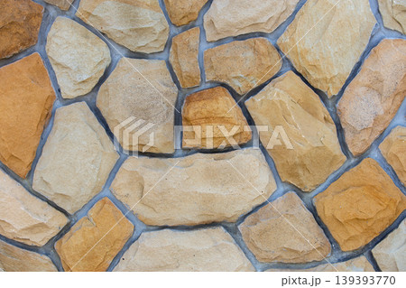 Abstract wall surface made from sand stones for usage as background. Abstract wall surface made from sand stones for usage as background. 139393770