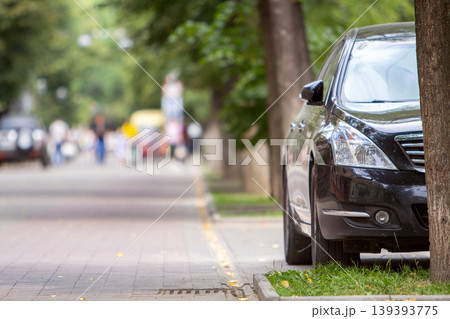 A car parked near curb on the side of the street on a parking lot. 139393775