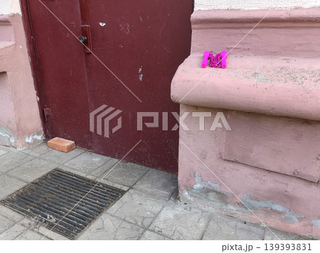 Pink jump rope resting on a textured wall ledge Pink jump rope resting on a textured wall ledge 139393831