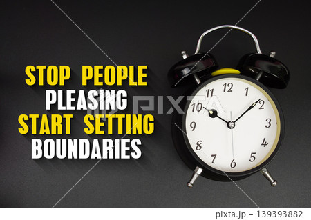 Stop People Pleasing Start Setting Boundaries text with alarm clock on black background 139393882