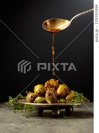 Spicy green olives are poured with olive oil with spices. Spicy green olives are poured with olive oil with spices. 139393994