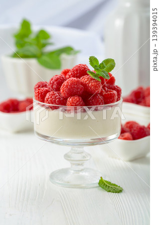 Panna cotta with fresh raspberries. 139394015
