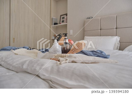 Self-care essentials on bed creating a relaxed morning routine Self-care essentials on bed creating a relaxed morning routine 139394180