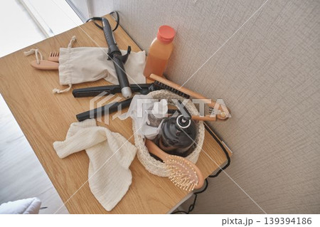 Hair care and beauty routine items on wooden surface Hair care and beauty routine items on wooden surface 139394186