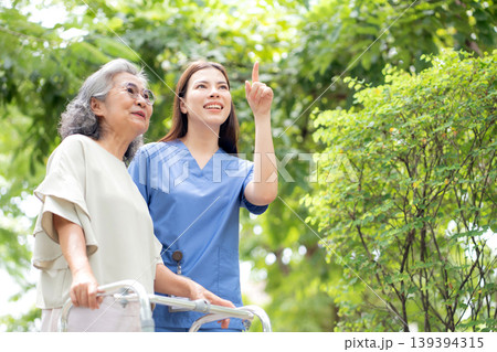 Asian female caregiver assistance senior patient with walker for physical rehabilitation and therapy Asian female caregiver assistance senior patient with walker for physical rehabilitation and therapy 139394315