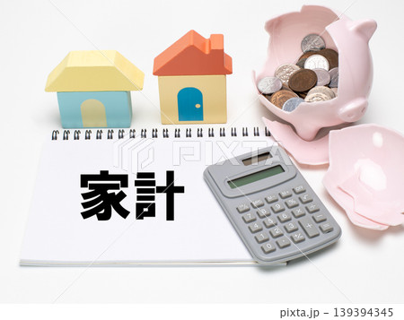 積み木の家と割れた豚の貯金箱と電卓で家計のイメージ 積み木の家と割れた豚の貯金箱と電卓で家計のイメージ 139394345