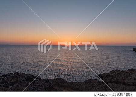 The peaceful sea at dawn or dusk, with serene and calm waters. The peaceful sea at dawn or dusk, with serene and calm waters. 139394897