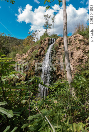 Natural Waterfall Flowing Down a Rocky Cliff Natural Waterfall Flowing Down a Rocky Cliff 139394898