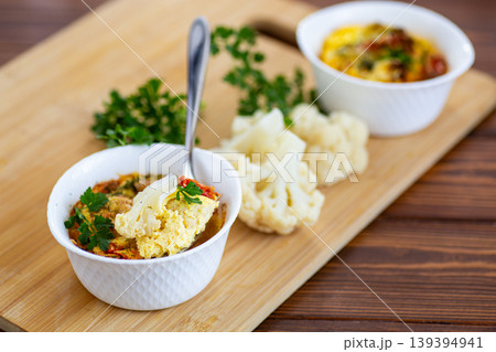 rustic breakfast omelet with cauliflower on wooden board background rustic breakfast omelet with cauliflower on wooden board background 139394941