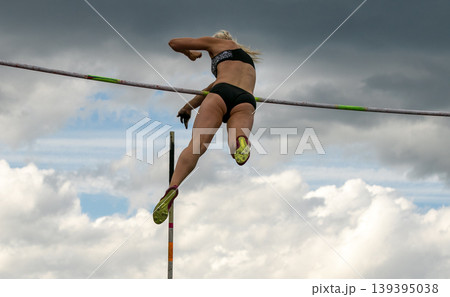 Female athlete flight over bar 139395038