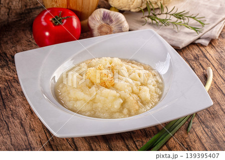 Homemade cauliflower puree with spices in a white bowl on a rustic wooden table Homemade cauliflower puree with spices in a white bowl on a rustic wooden table 139395407