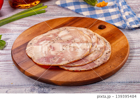 Sliced pork terrine with spices on round wooden board Sliced pork terrine with spices on round wooden board 139395484