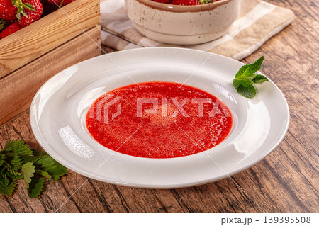 Fresh strawberry soup with mint garnish and ripe berries on rustic wooden table 139395508