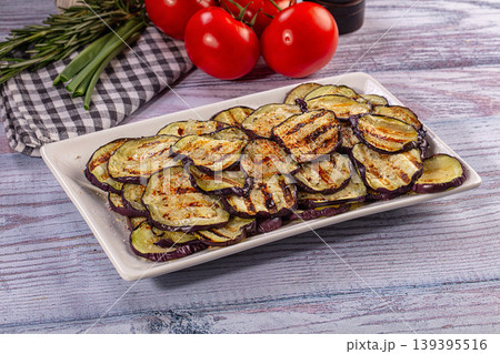 Grilled eggplant slices on white plate with fresh tomatoes and herbs Grilled eggplant slices on white plate with fresh tomatoes and herbs 139395516