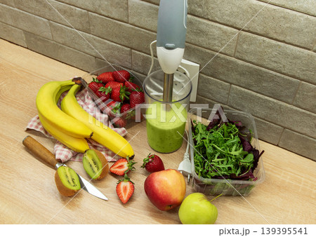 Preparing a healthy green smoothie with fresh fruits Preparing a healthy green smoothie with fresh fruits 139395541
