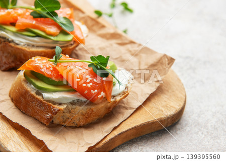 Salmon avocado toast with cream cheese and greens Salmon avocado toast with cream cheese and greens 139395560