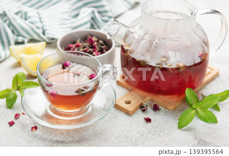 Rosebud herbal tea pouring into glass cup Rosebud herbal tea pouring into glass cup 139395564