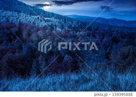 mysterious view of an autumn scenery in carpathian mountains at night. full moon over trees on the edge of a hill in fall colors. wonderful forested mountain landscape of ukraine mysterious view of an autumn scenery in carpathian mountains at night. full moon over trees on the edge of a hill in fall colors. wonderful forested mountain landscape of ukraine 139395888
