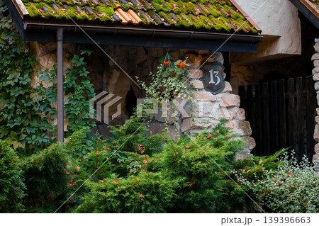 manor charming stone house with a mossy roof and lush greenery medieval aesthetic architecture featuring a house number 13 on the wall manor charming stone house with a mossy roof and lush greenery medieval aesthetic architecture featuring a house number 13 on the wall 139396663