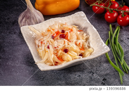 Fermented cabbage salad with cranberries and fresh vegetables on dark background 139396886