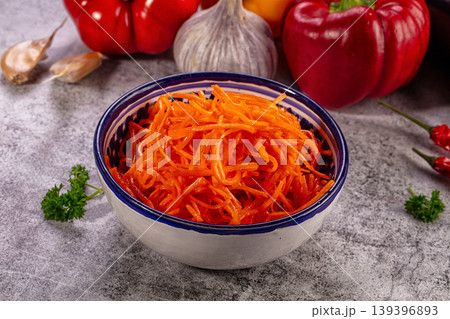 Spicy Korean carrot salad in ceramic bowl with garlic and pepper ingredients Spicy Korean carrot salad in ceramic bowl with garlic and pepper ingredients 139396893
