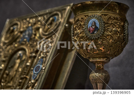 Ornate Orthodox church chalice with icon of Jesus Christ, religious liturgical object close up 139396905