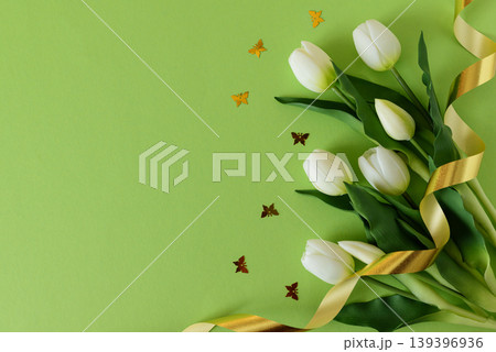 White Tulips and Butterflies Confetti with Ribbon on Green Spring Background White Tulips and Butterflies Confetti with Ribbon on Green Spring Background 139396936