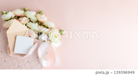 Pink Gift Bag with Flowers and Card on Pink Background 139396949