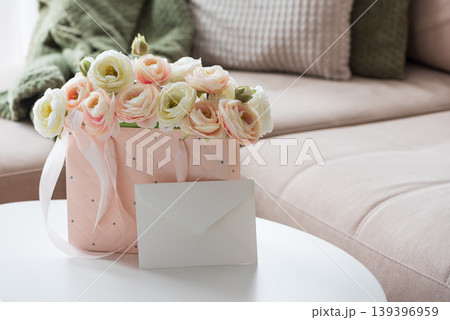 Ranunculus Bouquet with Gift Bag and Envelope in Cozy Living Room Ranunculus Bouquet with Gift Bag and Envelope in Cozy Living Room 139396959