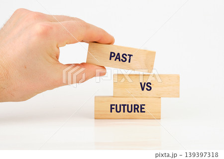 Hand places past block over vs future blocks, symbolizing choice direction 139397318