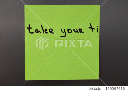 Take your time reminder note on a bright green sticky paper 139397616