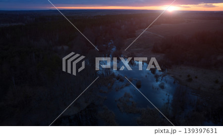 Romantic twilight aerial landscape with sunset glare over a spooky swamp and countryside Romantic twilight aerial landscape with sunset glare over a spooky swamp and countryside 139397631