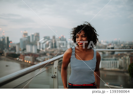 Portrait of a beautiful woman standing on terrace of modern building. 139398064