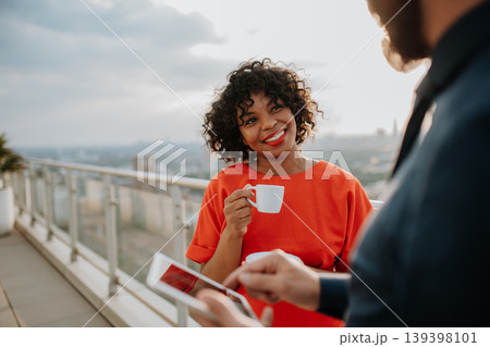 Real estate agent talking to client on the rooftop of a modern building Real estate agent talking to client on the rooftop of a modern building 139398101