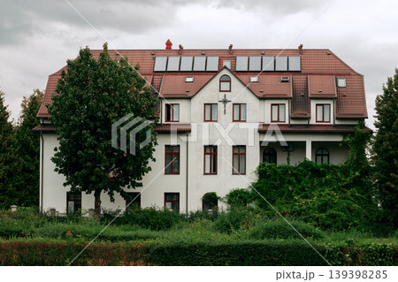 Spacious white country manor house with red tiled roof and solar panels Spacious white country manor house with red tiled roof and solar panels 139398285