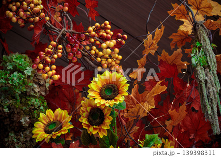 Vibrant autumn harvest decoration with sunflowers, berries, and fall leaves Vibrant autumn harvest decoration with sunflowers, berries, and fall leaves 139398311