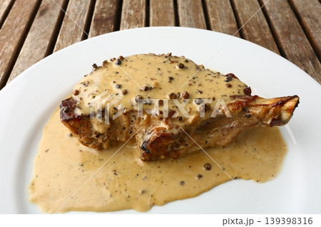 Entrecote Steak with Green Pepper Sauce on Plate 139398316