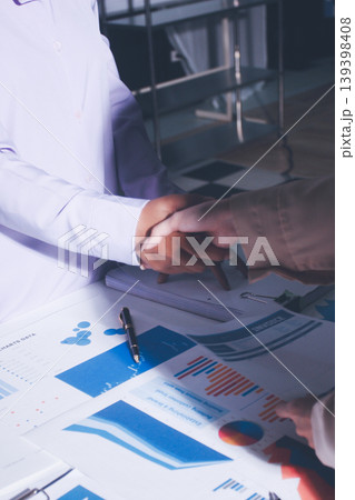 Above table with finance papers, graphs and big data during teamwork meeting with accounting or marketing team discussing budget, strategy or growth development. Closeup of SEO team doing research 139398408