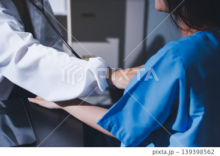 healthy concept; Doctor checking patient's heart with stethoscope at a hospital 139398562