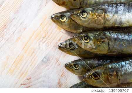 Salted sardines on wooden surface 139400707