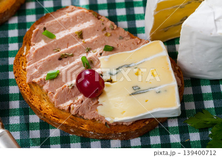 Toasted bread with rillettes and soft blue cheese Toasted bread with rillettes and soft blue cheese 139400712