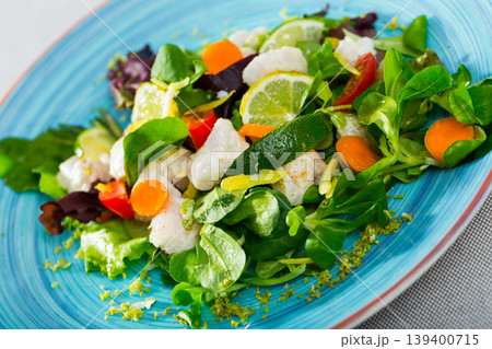 Deliciously salad of hake with lemon, lettuce leaves and fresh carrots Deliciously salad of hake with lemon, lettuce leaves and fresh carrots 139400715