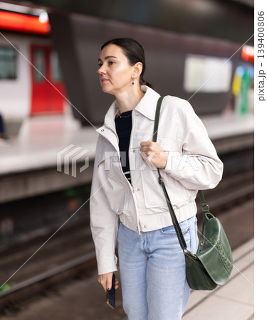Portrait of woman at metro station waiting for train Portrait of woman at metro station waiting for train 139400806