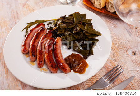 Fried sausages served with green beans at plate Fried sausages served with green beans at plate 139400814