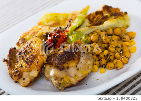 Fried chicken thighs with breaded cabbage, chickpeas, sauces 139400825