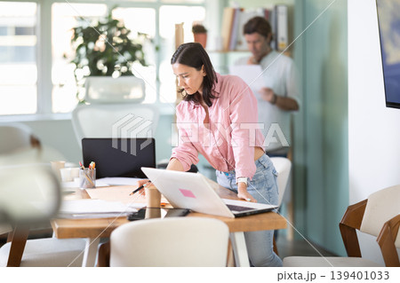 Adult man reviewing document, woman looks construction plan Adult man reviewing document, woman looks construction plan 139401033