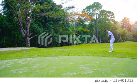Golfers are putting golf in the evening golf course golf backglound. Golfers are putting golf in the evening golf course golf backglound. 139401312